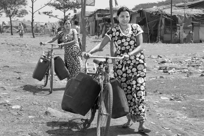 Human Right to Water in Mumbai - In the absence of public water supply, transporting water purchased from a distant group connection